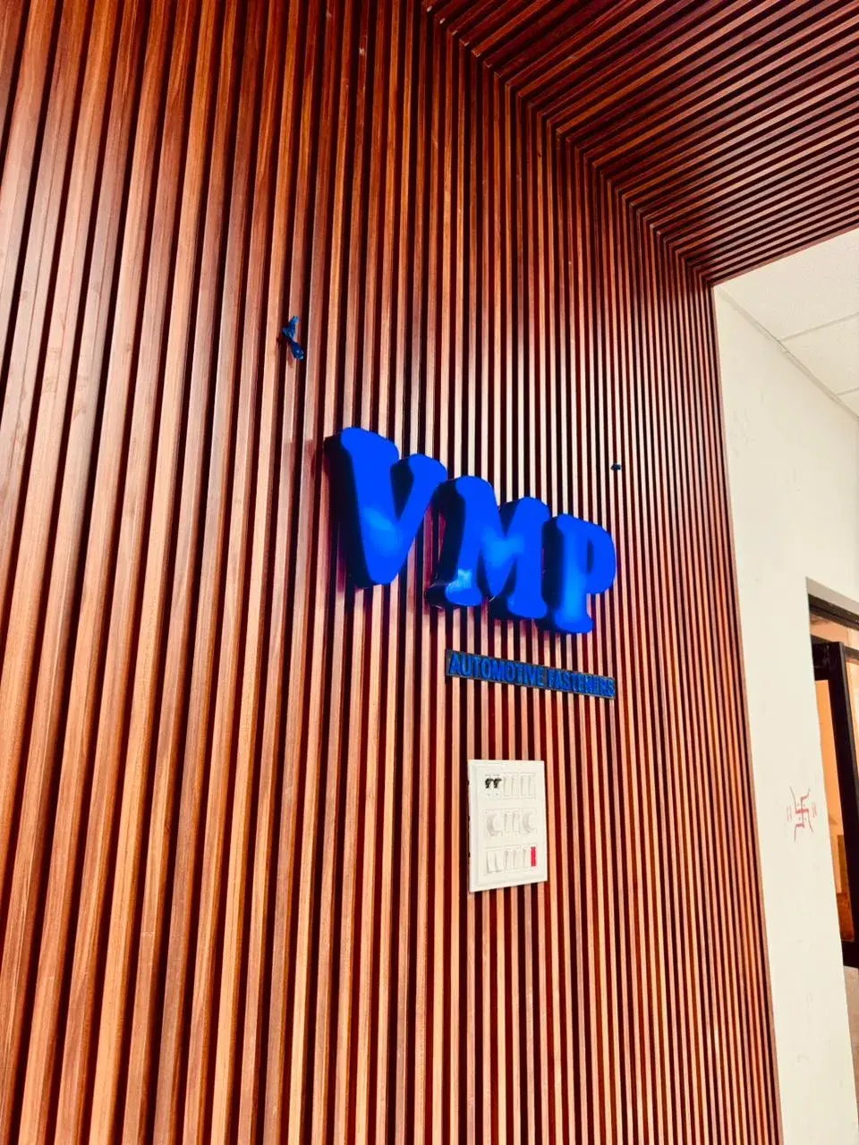 VMP reception signage on wood-panelled wall